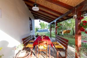 a dining room with a table and chairs on a patio at Tri breze Vodanj in Vodanj