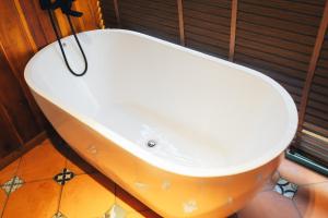 a white bath tub sitting in a bathroom at Đàng Trong Home 2 in Xóm Rạch Rô