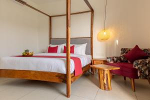 a bedroom with a canopy bed and a couch at Aayovea Resort Ayodhya Near Ram Mandir & Saryu River in Ayodhya