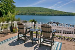 a table with two chairs and a glass of wine at The View at Harbor Lights in Hammondsport
