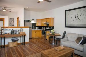 a living room with a couch and a kitchen at The View at Harbor Lights in Hammondsport