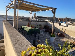 a patio with a table and chairs on a roof at Oasi nel Salento in Tricase