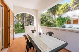 a dining room with a table and chairs at Villaggio Baia Dei Lombardi in Vieste
