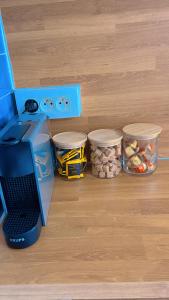 a kitchen with three containers of food and a printer at 100m de la plage in La Grande Motte