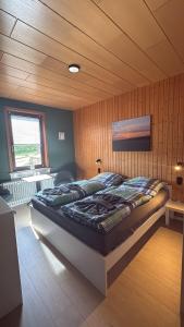 a bedroom with a large bed in a room at Pension moos & morgenrot - St Andreasberg in Sankt Andreasberg