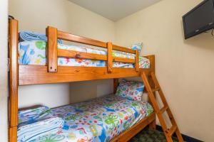 a bedroom with two bunk beds and a tv at The Branson Waterpark Hotel in Branson +25 photos