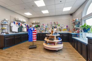 a store with dark brown cabinets and a large room at The Branson Waterpark Hotel in Branson