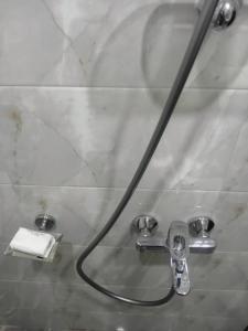 a shower head with a hose in a bathroom at Margalla Hills View Apartment Islamabad in Islamabad +52 photos
