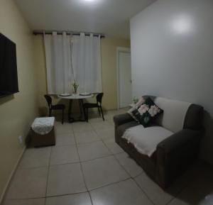 a living room with a couch and a table at Cantinho da Deusa in São José de Ribamar