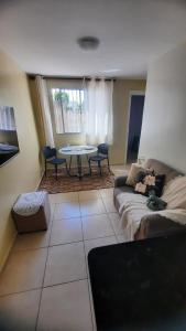 a living room with a couch and a table at Cantinho da Deusa in São José de Ribamar