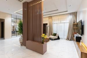 a lobby with a living room with a couch and a tv at Mirage in Lekki