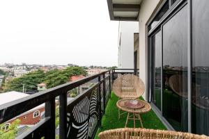 a balcony with a rattan chair and a table at Mirage in Lekki