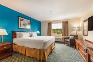a hotel room with a bed and a desk at The Branson Waterpark Hotel in Branson