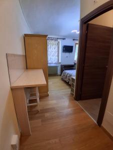 a room with a desk and a bed and a door at Agriturismo Cascina Marchesa in Bussoleno