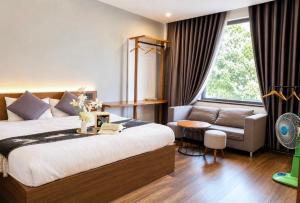 En eller flere senge i et værelse på TTR Studio Apart' Hotel Dalat