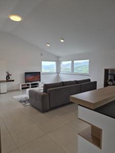 a living room with a couch and a tv at Hiša Naj in Koper