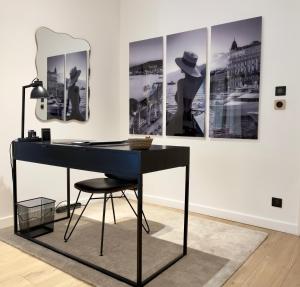 a desk in a room with three paintings on a wall at Luxury Elegance Comfort 3-room apartment of 80m2 with 2 BDR 2 BA 3 min Croisette & Beach in Cannes
