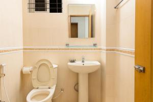 a bathroom with a toilet and a sink at Baral White Rose Hotel Dhaka in Dhaka +18 photos