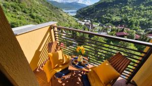 a balcony with a table and chairs with a view at Panorama Apartment in Mavrovo +26 photos