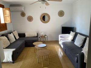 a living room with a couch and a table at Stunning views, 3 bed, private pool, olive grove in Iznájar