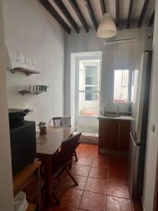 eine Küche mit einem Tisch mit Stühlen und einem Fenster in der Unterkunft FlorCactus in Níjar