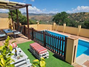 a backyard with a swimming pool and a fence at Cortijo Molino los Justos in Fuentes de Cesna