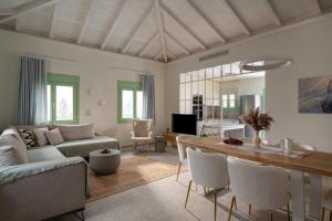 a living room with a couch and a table at Pnoe Luxury Villa - Private Pool Retreat & BBQ in Ierissos