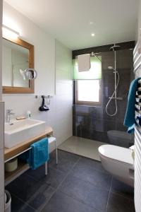 a bathroom with a sink and a toilet and a shower at Gästehaus Steinerhof in Nikolsdorf +135 photos