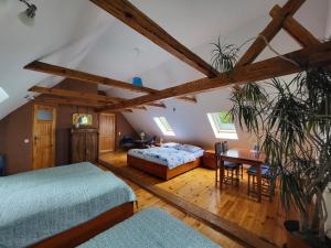 a bedroom with two beds and a table in a room at Gajowe Zacisze in Mirsk