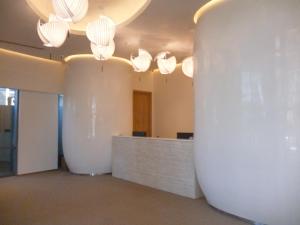 a lobby with white lights and a reception desk at batumi orbi sea tawers in Batumi