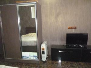 a hotel room with a mirror and a television at batumi orbi sea tawers in Batumi
