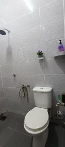 a bathroom with a white toilet and a shower at Homestay Cikgu 2 Hospital Kuala Krai in Kuala Kerai