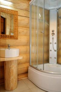 a bathroom with a shower and a sink at Pensiunea Larix in Răchiţele