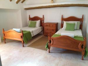 a bedroom with two beds and a dresser at Stunning views, 3 bed, private pool, olive grove in Iznájar +20 photos