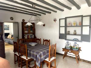 a dining room with a table and chairs in a room at Stunning views, 3 bed, private pool, olive grove in Iznájar