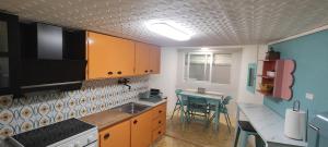 a kitchen with a sink and a table in it at Cal Pataqué, house in Arnes in Arnés +3 photos
