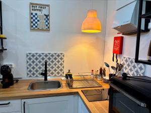 a kitchen with a sink and a counter top at Casinha do Solar in Angra do Heroísmo