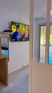 a flat screen tv on a wall in a room at 100m de la plage in La Grande Motte