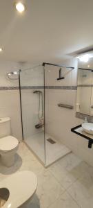 a bathroom with a glass shower and a toilet at Cal Pataqué, house in Arnes in Arnés