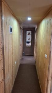 a hallway with wood paneled walls and a long corridor at Cabaña Gazul in Porvenir