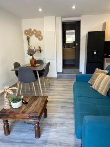 a living room with a blue couch and a table at Charmant appartement à Ajaccio in Ajaccio