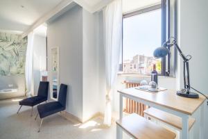 a desk and a chair in a room with a window at L'AFFACCIO in Catania