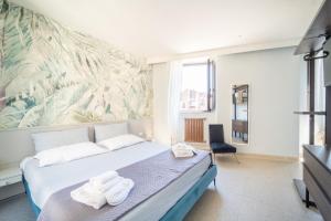 a bedroom with a bed with two towels on it at L'AFFACCIO in Catania