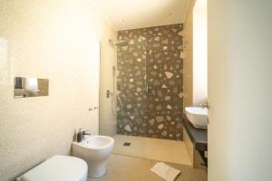 a bathroom with a shower and a toilet and a sink at L'AFFACCIO in Catania +49 photos