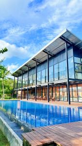 a large building with a pool in front of it at Ceylon Elegance Villa in Kurunegala