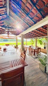 a restaurant with wooden tables and chairs and a ceiling at Ceylon Elegance Villa in Kurunegala