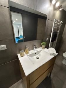 a bathroom with a white sink and a mirror at Charmant appartement à Ajaccio in Ajaccio +18 photos