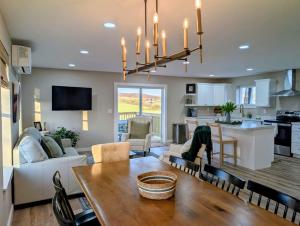 a kitchen and living room with a table and a dining room at Scenic Homestead Barndominium in Dryden