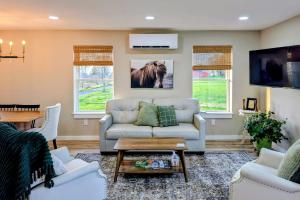 a living room with a couch and a tv at Scenic Homestead Barndominium in Dryden