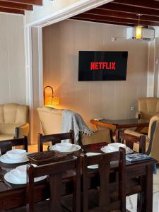 a restaurant with tables and chairs and a sign on the wall at Chalet duplex N 7 avec piscine in Bouzareah